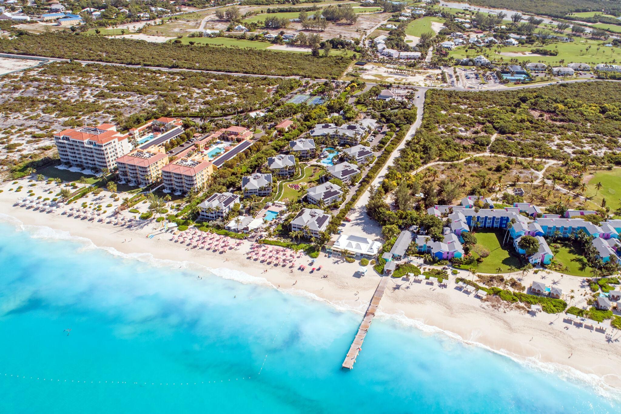 Aerial view of beachfront resorts and turquoise water in Turks and Caicos